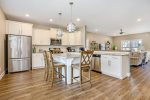 The fully equipped kitchen with stainless steel appliances has everything needed to prepare and serve meals to large groups. A grill and patio furniture also make outdoor cooking & dining an option.